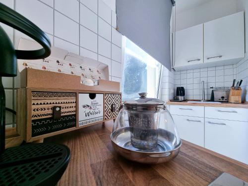 a kitchen with a glass bowl on a wooden table at Alpha Apartments in Essen