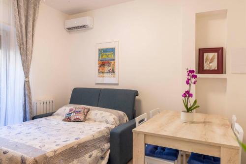 um pequeno quarto com uma cama e uma mesa em Bed E-bike em Ancona