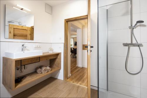 a bathroom with a sink and a shower at Haus Bergwelten in Bischofswiesen