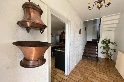 a copper sink on the wall of a house at Les Gites de Louisette 1886 in Ébreuil