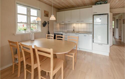 a kitchen with a table and chairs and a refrigerator at Gorgeous Home In Slagelse With Wifi in Slagelse