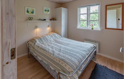 a bedroom with a bed in a room with a window at Nice Home In Slagelse With 3 Bedrooms And Wifi in Slagelse