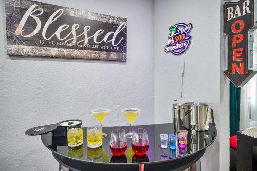 a table with wine glasses on it with a sign at Vacay Spot Happy Escape 15 Min Beach Massage Shower Prime LOC! 6 blocks away from Bars, Nite Clubs, Res, Shops in Miami
