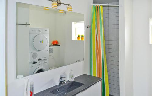 a bathroom with a sink and a washing machine at 3 Bedroom Amazing Home In Frederikshavn in Frederikshavn