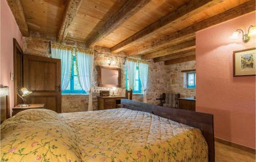 a bedroom with a bed in a room with wooden ceilings at Villa Giselle in Vižinada