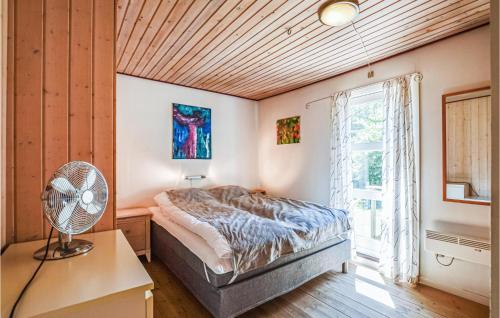 a bedroom with a bed and a window and a fan at Beautiful Home In Vig With 4 Bedrooms, Sauna And Wifi in Vig