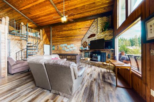 a living room with a couch and a television in a house at The Coffee Grounds in Johnson Landing