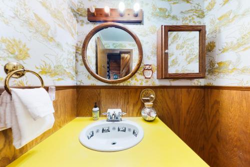 a bathroom with a sink and a mirror at The Coffee Grounds in Johnson Landing