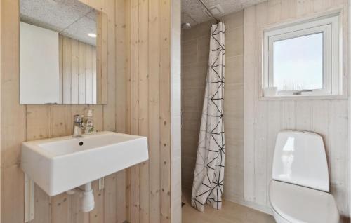 a bathroom with a white sink and a mirror at Amazing Home In Haderslev With Kitchen in Kelstrup Strand