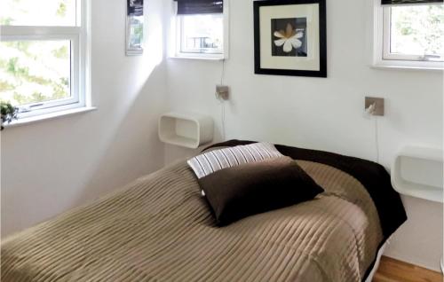 a bedroom with a bed with a pillow on it at Pet Friendly Home In Knebel With Wifi in Knebel