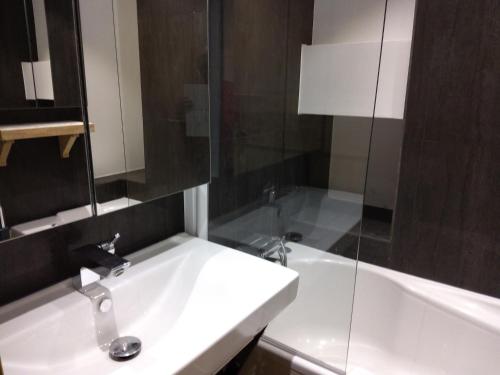 une salle de bain avec un lavabo et une baignoire dans l'établissement Charmant 2 pièces au centre de Méribel avec balcon et WiFi - FR-1-411-872, à Les Allues