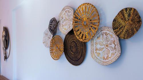 a group of plates hanging on a wall at Star Beach apartment in Kastrí