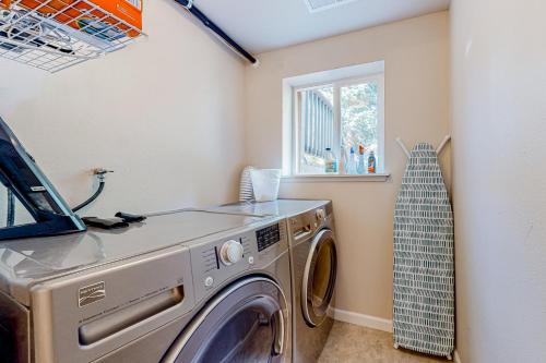 a washing machine in a laundry room with a window at Rowandale in University Place