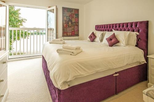 a large bed with towels on it in a bedroom at Windrush Lake 65, Sunset Lodge - P in South Cerney