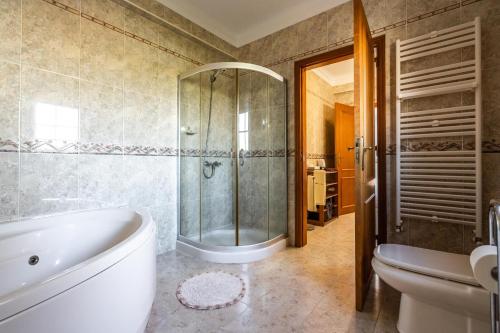 a bathroom with a tub and a shower and a toilet at Akivillas Sintra Delicacy in Sintra