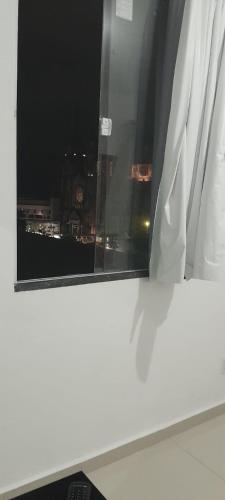 a window with a view of a city at night at Central Palace Hotel in Fortaleza