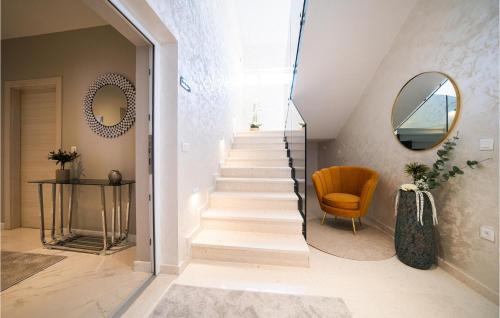 a staircase in a home with a mirror and a chair at Villa D-palace in Žarović