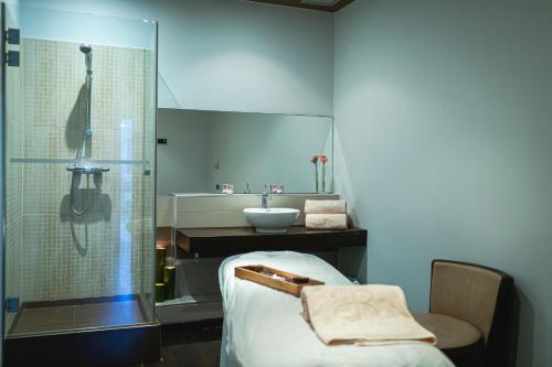 a bathroom with a sink and a shower at AR Roca Esmeralda & SPA Hotel in Calpe