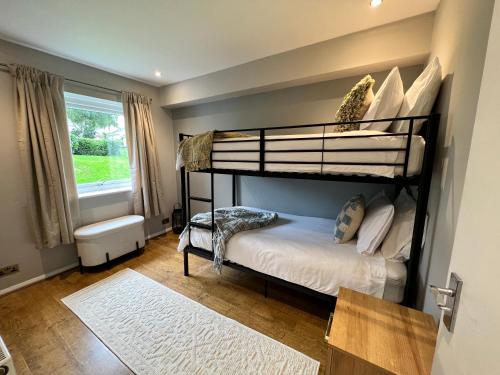 a bedroom with two bunk beds and a window at Stylish Getaway in Y Felinheli Marina in Y Felinheli