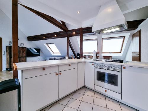 a kitchen with white cabinets and a stove at Alpha Apartments in Essen