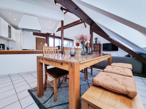 a dining room with a wooden table and chairs at Alpha Apartments in Essen