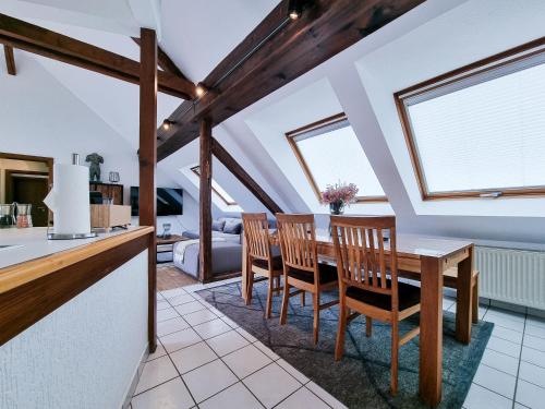 a kitchen and dining room with a table and chairs at Alpha Apartments in Essen