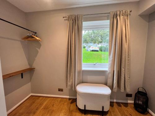 a room with a stool and a window at Stylish Getaway in Y Felinheli Marina in Y Felinheli
