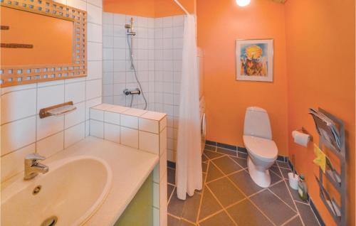 a bathroom with a sink and a toilet at Holiday Home Kalvehavestien Glesborg Xi in Fjellerup Strand