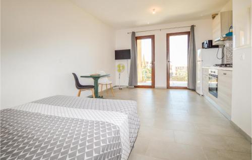 a bedroom with a bed and a table and a kitchen at Lovely Apartment In Piana With Wifi in Piana