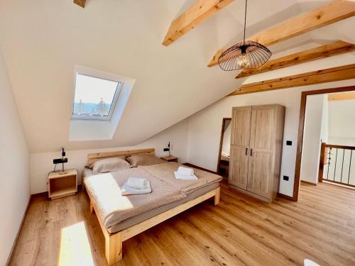 a bedroom with a bed in a room with wooden floors at Vila Milan in Bled