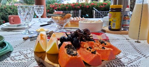 a table with a plate of food on a table at Pousada Jardim da Lagoa-BA in Bom Jesus da Lapa