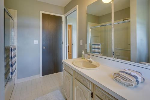 a bathroom with a sink and a mirror at Lakefront Michigan Rental with Kayak and Fire Pit 