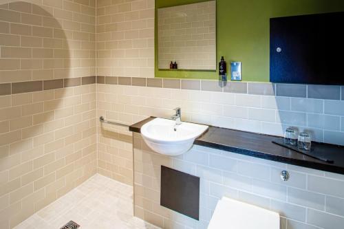 a bathroom with a sink and a mirror at Eton House - Self Check-In, Ensuite Rooms & Self-Catering Studios in Yeovil