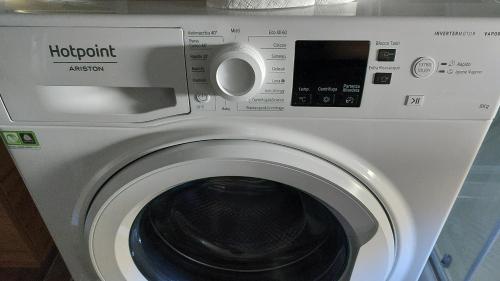 a washing machine with a washer in a room at Sicily Holidays Home in Calatabiano