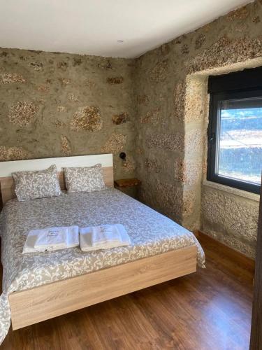 a bedroom with a bed in a room with a window at Solar do Prazo-Serra & Charme in Gonçalo
