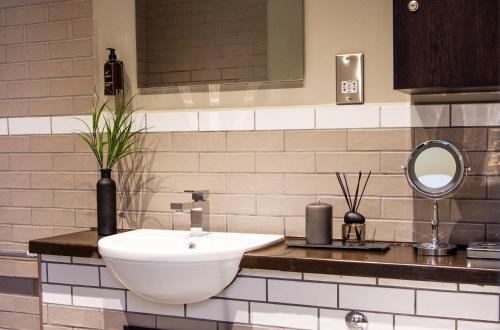 a bathroom with a white sink and a mirror at Eton House - Self Check-In, Ensuite Rooms & Self-Catering Studios in Yeovil
