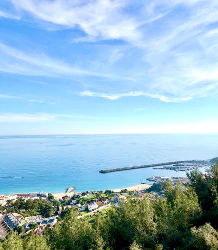 a view of a beach and the ocean at Sesimbra Cozy House BBQ & Terrace - MADA HOUSE's in Sesimbra