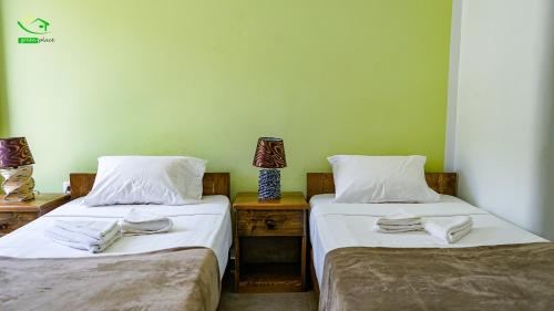 two beds sitting next to each other in a room at Pousada Green Place in Ribeira Grande