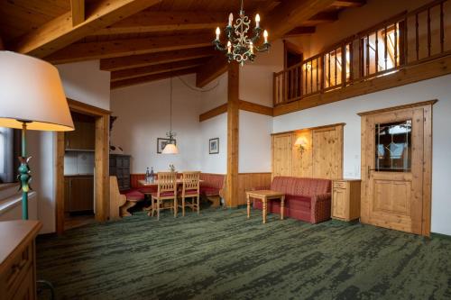 a living room with a table and a dining room at Zugspitz Resort in Ehrwald