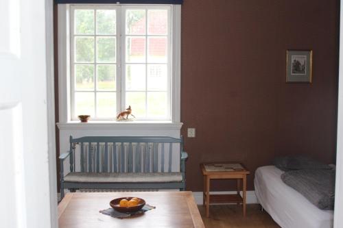 a bedroom with a bed and a bowl of fruit on a table at Yxkullsund Säteri B&B - Manor & Estate since 1662 in Lagan