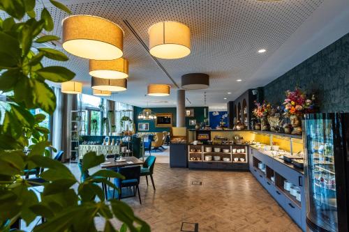 a restaurant with blue walls and tables and chairs at Karls Hotel in Sigmaringen
