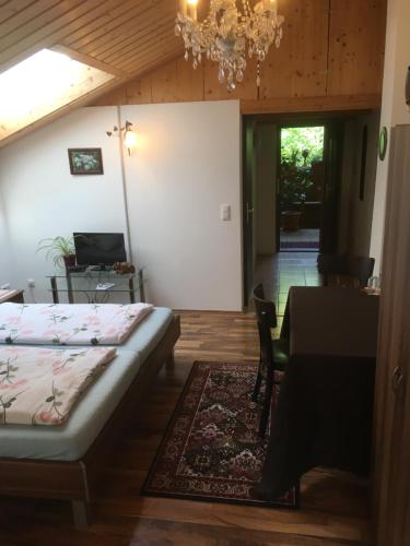 a bedroom with a bed and a table and a dining room at Pension Zur Freiheit in Passau