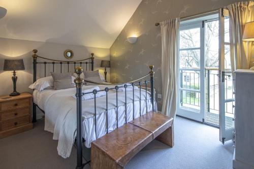 a bedroom with a large bed and a window at Mill Village 68, Somer House - P in Somerford Keynes