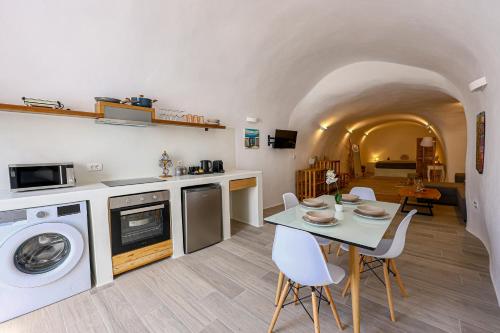a kitchen with a table and a washer and dryer at Tree of Life 2 - Authentic Cave - Style Home by ΜΡS in Vóthon