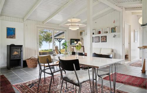 a dining room with a table and chairs and a fireplace at 3 Bedroom Gorgeous Home In Knebel in Knebel