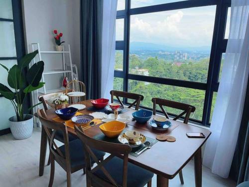 a dining room table with chairs and a large window at Mango House6-High floor I Biggest unit I SeaView I Waterfilte I Wifi-JQ in Kota Kinabalu