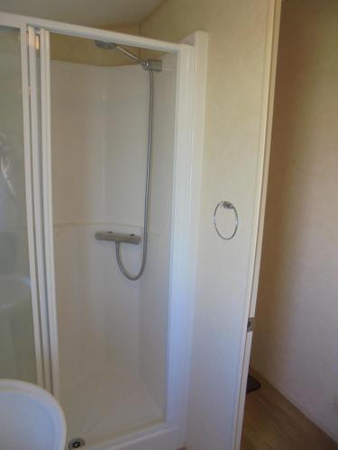 a shower with a glass door in a bathroom at Golden Sands: Richmond GS:- 6 berth, Blow heated, Access to the beach in Ingoldmells