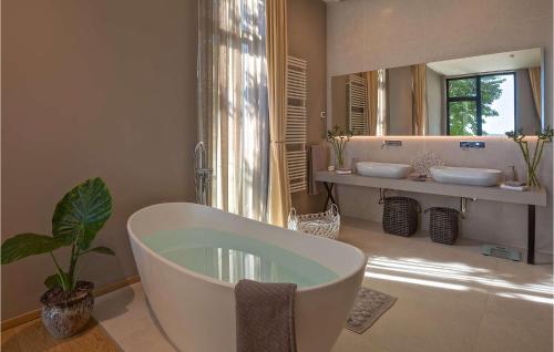 a bathroom with a tub and two sinks and a mirror at Villa Lorena in Novigrad Istria