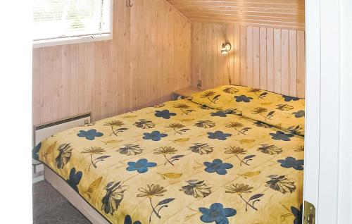 a bedroom with a bed with blue flowers on it at Amazing Home In rsted With 3 Bedrooms, Sauna And Wifi in Kare