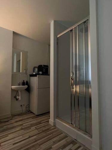 a bathroom with a glass shower and a sink at Cozy Private Room 1 on a Busy Persian Restaurant in Eindhoven